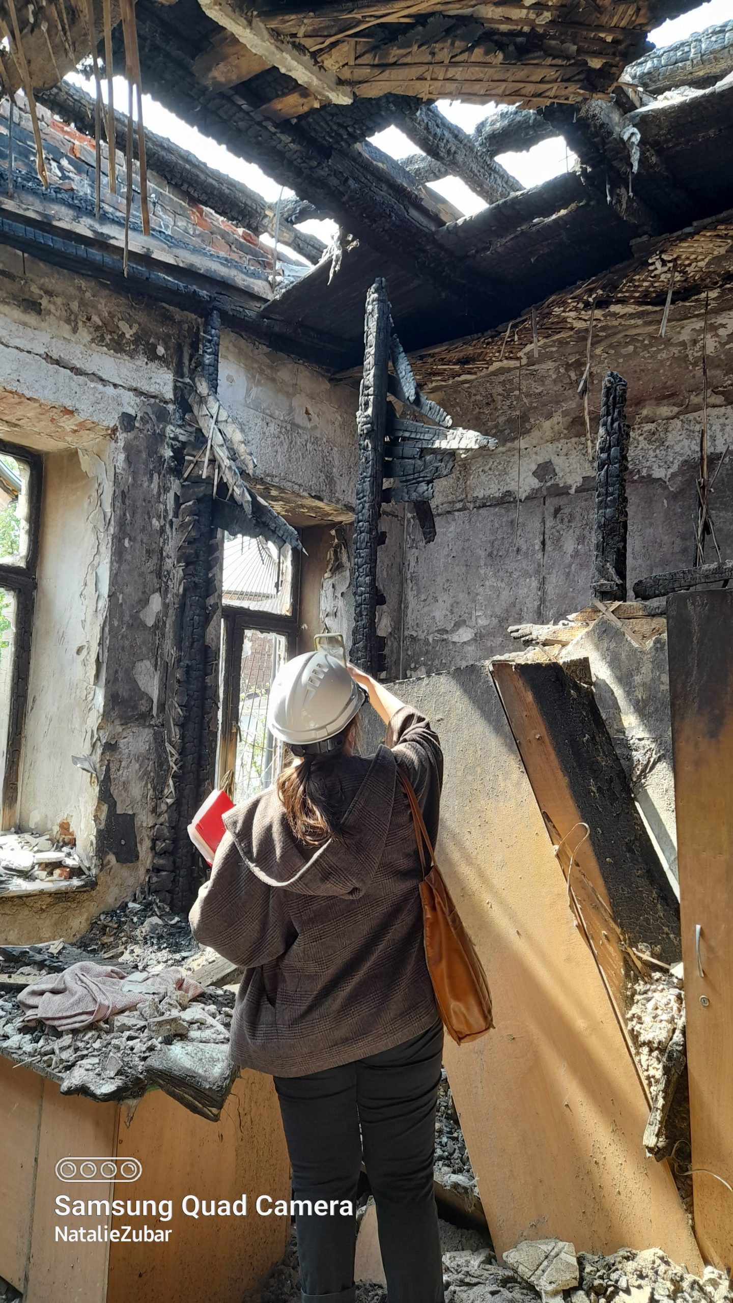 Architect surveys destructions of a historical monument. 