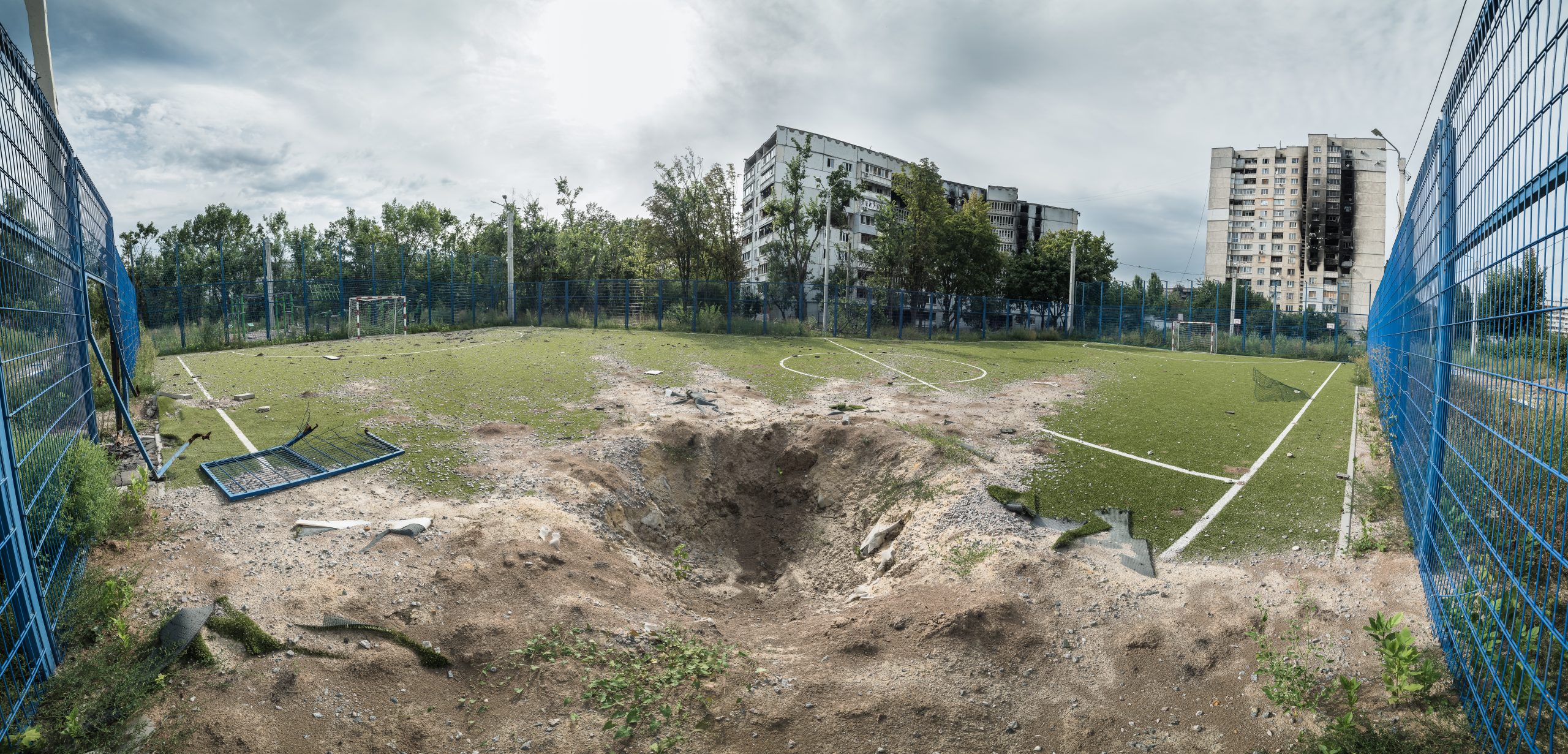 A crater on a football field in North Saltivka, Kharkiv.