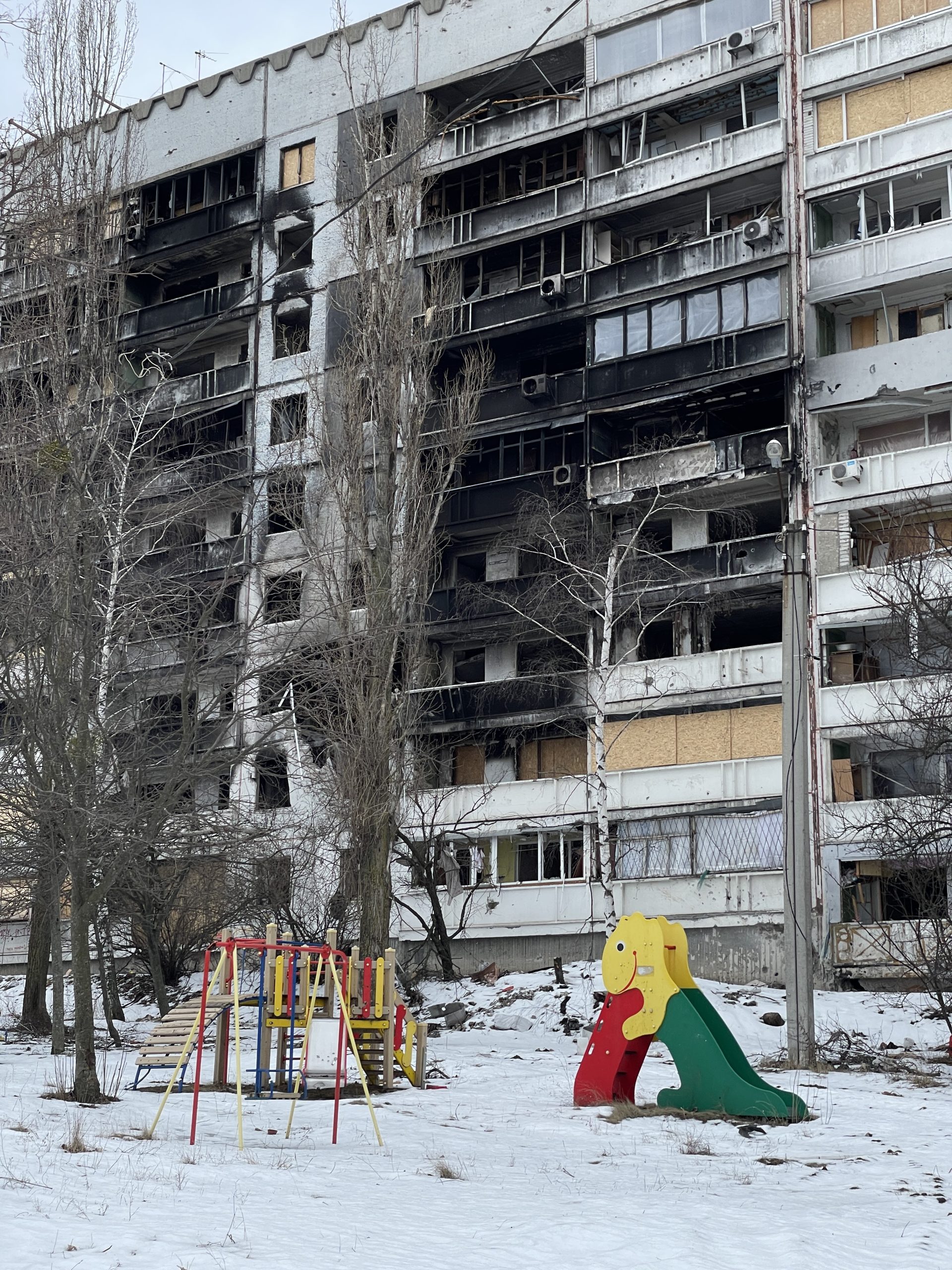 Kharkiv. Children's playground near a residential building in Pivnichna Saltivka. The building was shelled by the Russians several times, as a result of which it almost completely burned down. Photo was taken on on Feb 20, 2023 by Kateryna Svid.