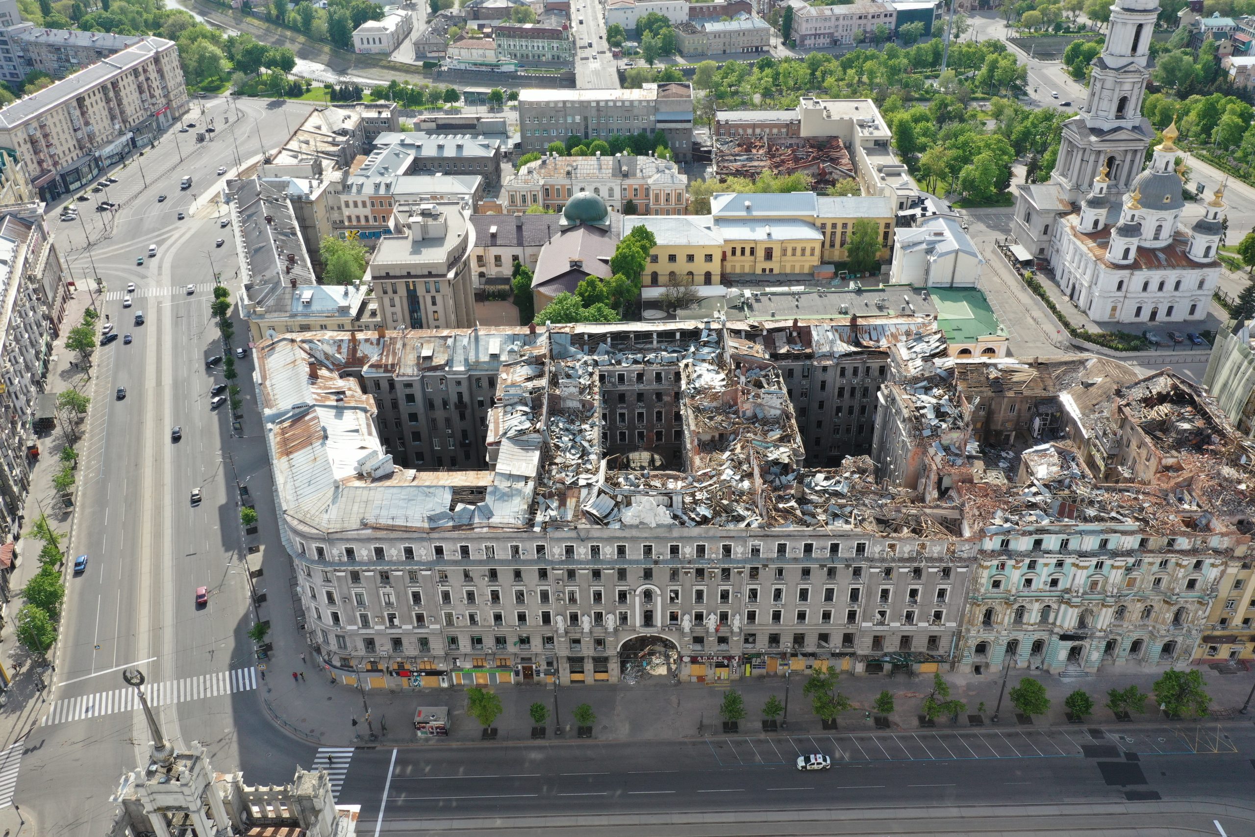 Constitution Square in the historical centre of Kharkiv. The grey office building, known as the Palace of Labour, was commissioned by the “Insurance Company Russia” and finished by 1916. It was hit by the rockets from a flyover Russian bomber on March 2, 2022. As seen from the drone on May 20, 2022.